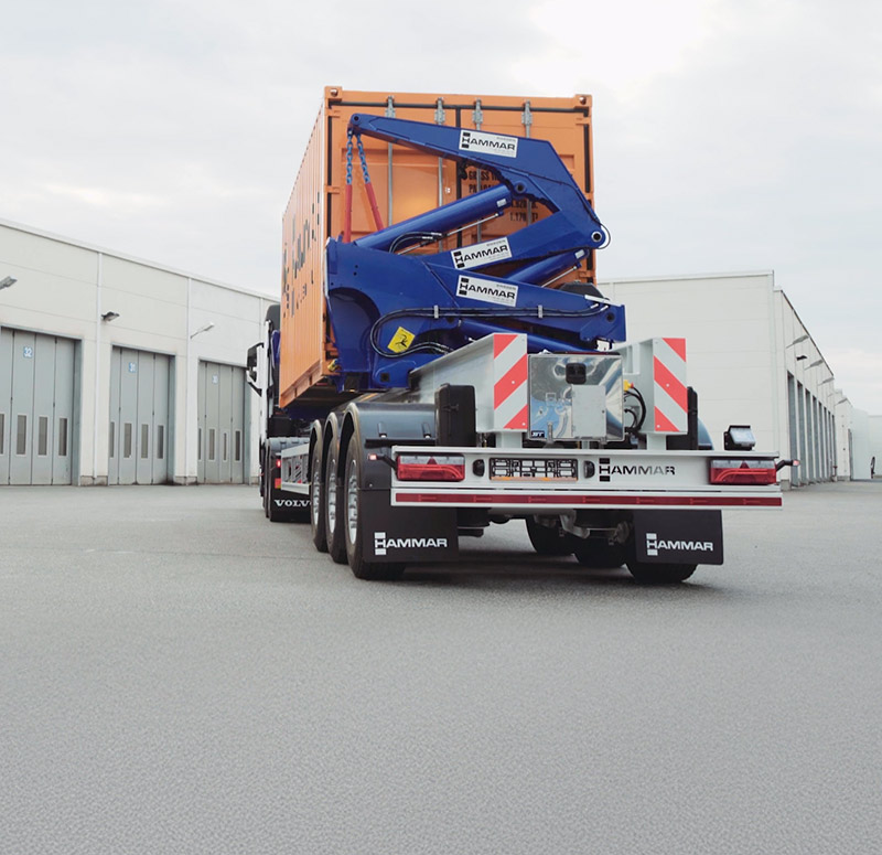 Hammar 195 sideloader with an orange container safely secured and ready for transport/relocation